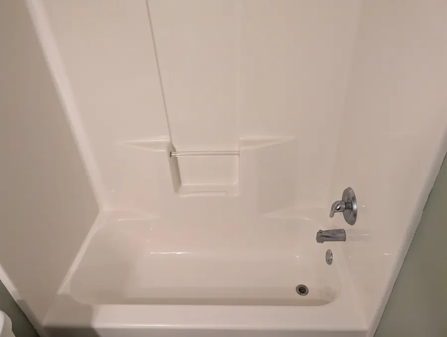 Bathtub and shower walls after professional deep cleaning removed heavy grime and stubborn stains in Fargo, ND